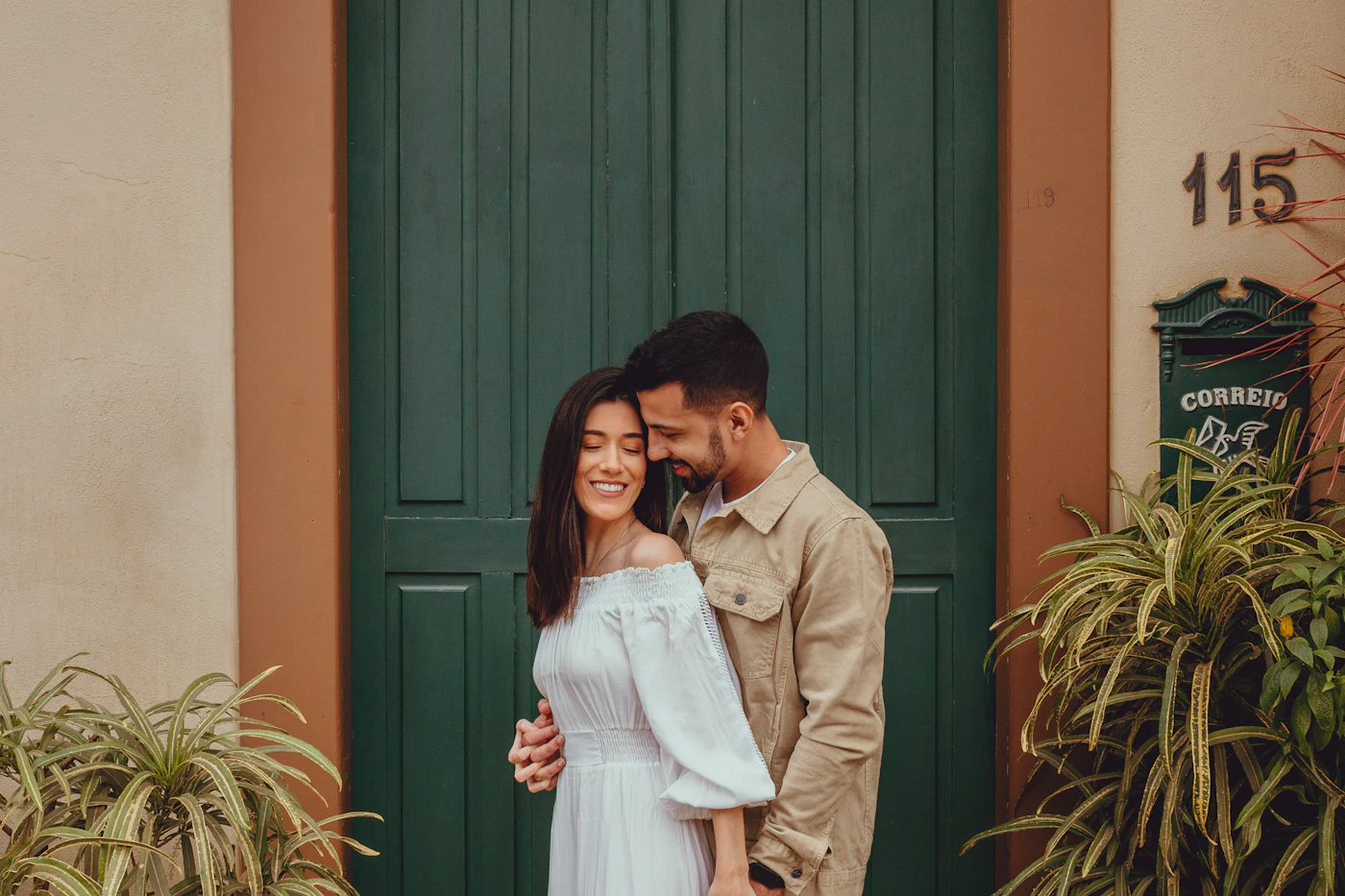 Couple standing together at the front door of their home