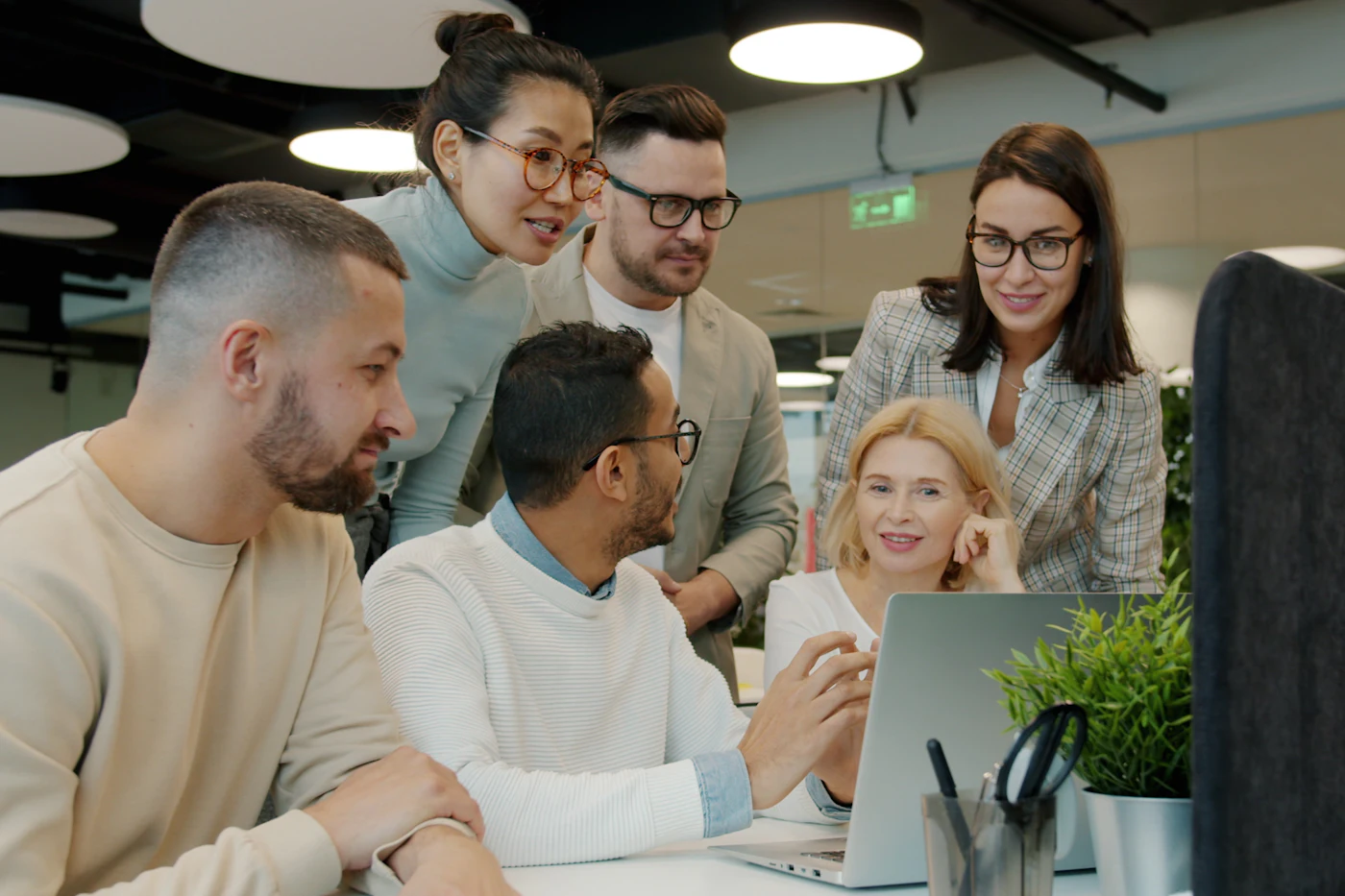 Team working together around a laptop
